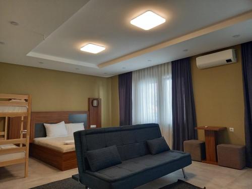 米特罗维察Hotel Centrum的客厅配有沙发和1张床