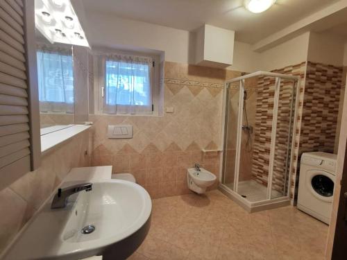 泰尔拉戈Villa Villi的一间带水槽、淋浴和卫生间的浴室