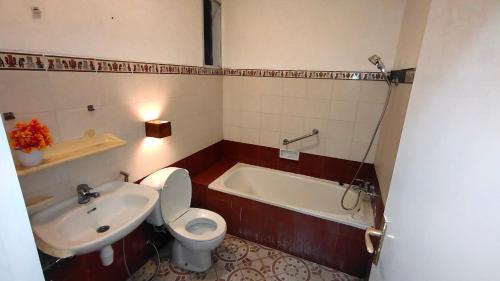 巴图Villa Klub Bunga Empat的浴室配有卫生间、盥洗盆和浴缸。