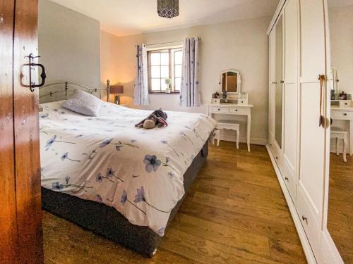 ShardlowWilne Cottage的一间卧室配有一张带梳妆台和书桌的床。