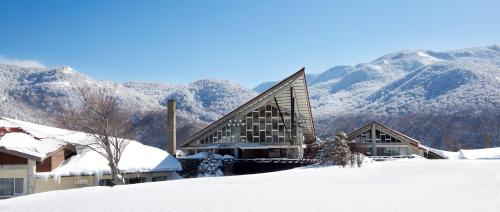 山之内町奥志贺高原酒店的一座山地雪地建筑