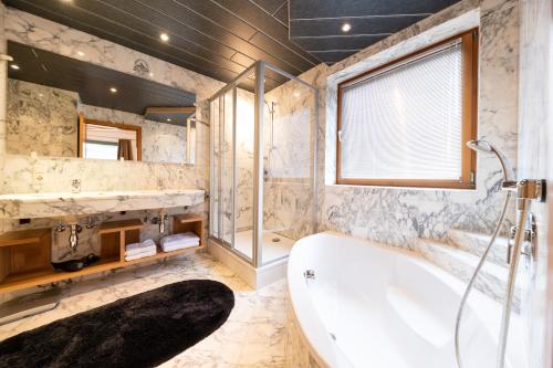 滨湖采尔阿兹特公寓酒店的一间带大浴缸和窗户的浴室