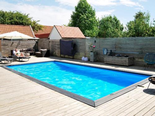马尔默4 person holiday home in MALM的木制甲板上的大型蓝色游泳池