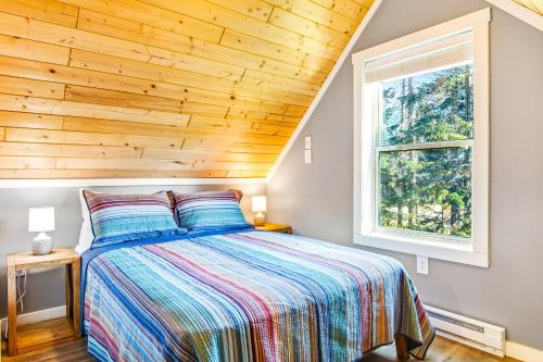 Snoqualmie PassSnowdrop Summit Cabin的一间卧室设有一张木天花板床。