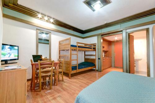 佩斯卡塞罗利普利穆拉公寓酒店的一间卧室配有双层床、一张桌子和一张桌子