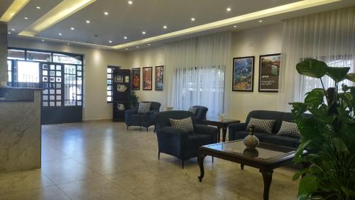 马达巴黑鸢尾酒店 的大堂配有沙发、椅子和桌子
