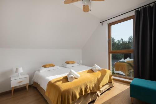 Lgota MurowanaMoje Miejsce Jura的一间卧室配有一张带黄色床单的床和一扇窗户。