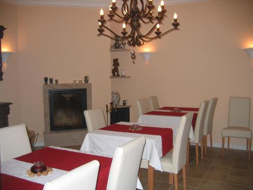 ForstGästehaus Oswald的一间带2张桌子和吊灯的用餐室