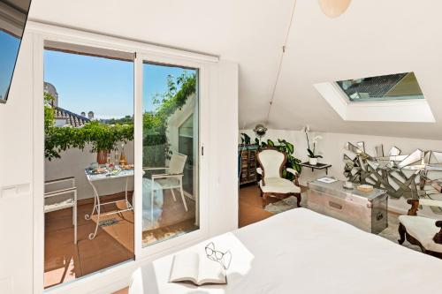 马贝拉Molo Luxury Suites Puerto Banus的白色的客房设有1个带桌椅的阳台。