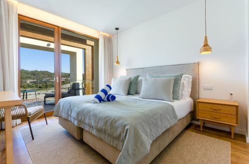 普拉亚德尔瑞伊West Cliffs Ocean and Golf Resort的一间带大床的卧室和一个阳台