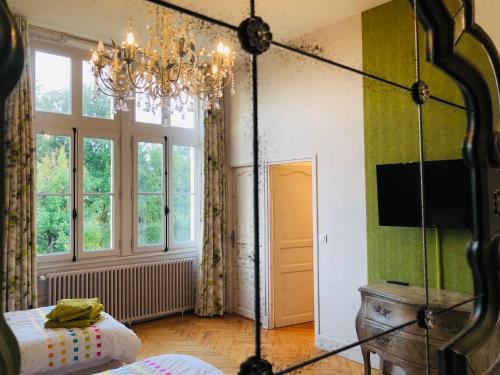 CardanChâteau Fauchey的一间卧室配有吊灯和一张位于客房内的床