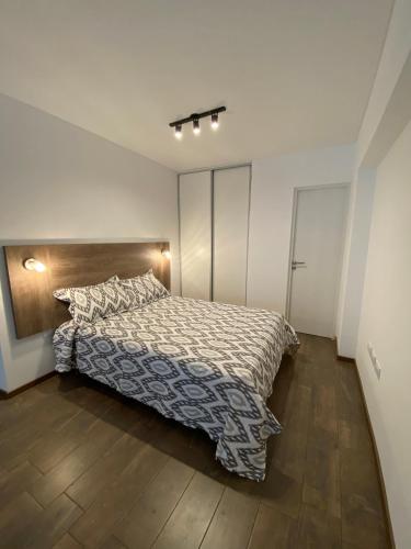 罗萨里奥Estudio completo en zona centro, a 200 metros del rio的一间卧室配有一张床,铺有木地板