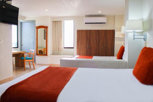 比亚埃尔莫萨瑞欧德拉果套房酒店的酒店客房设有一张大床和一张书桌。