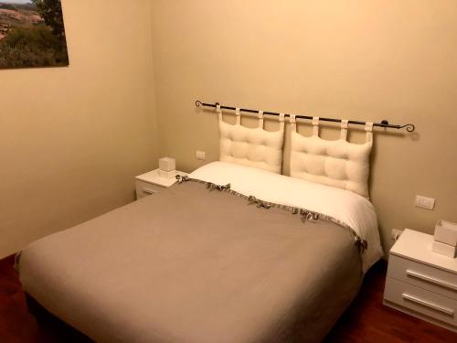 蒙特普齐亚诺Didi House的一间卧室配有带白色床单和枕头的床。