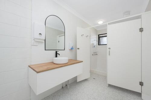 汤斯维尔Seaside Lodge Townsville的白色的浴室设有水槽和镜子