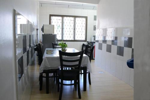 麻坡Wonderful Homestay at Muar的一间带桌子和黑色椅子的用餐室