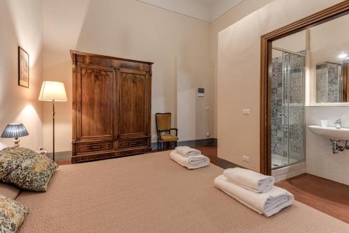 渥尔特拉Appartamenti Villa Mascagni的一间卧室配有一张带水槽和毛巾的床