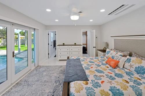 劳德代尔堡Moana Beach Cottage的一间卧室设有一张床和一个滑动玻璃门