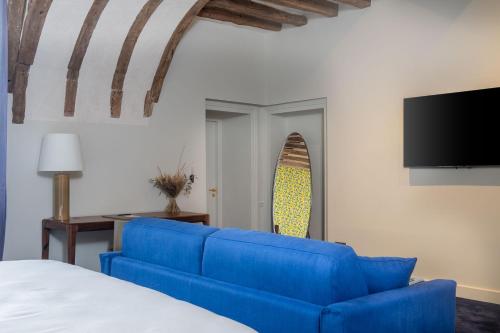 Vernou-en-SologneLa Borde en Sologne Château & Spa的客厅配有蓝色的沙发和电视