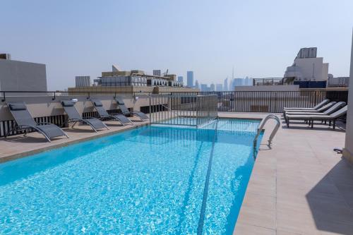 迪拜Azur Regency Hotel Apartments的建筑物屋顶上的游泳池