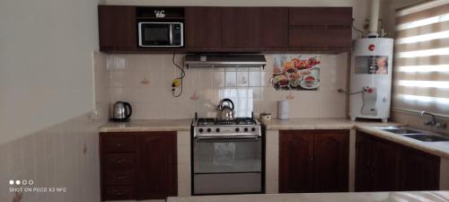 塔里哈Departamento El-Shaddai的一间带炉灶和微波炉的小厨房