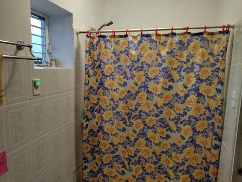 伯利兹城红色小屋旅馆的浴室里有一个蓝色和黄色的浴帘