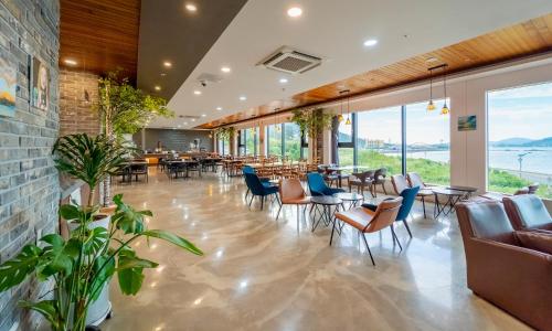 泗川艺术度假村水疗和泳池别墅的餐厅设有桌椅和窗户。
