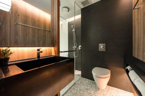 曼谷沃尔沃曼谷酒店的一间带水槽、卫生间和淋浴的浴室