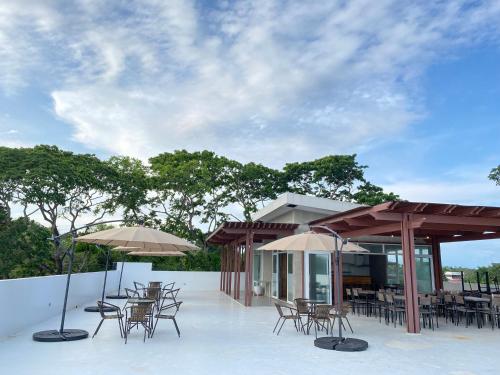 公主港Bambu Suites的一个带桌椅和遮阳伞的庭院
