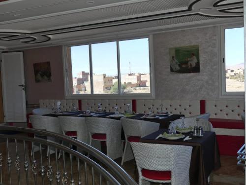 拉希迪耶Dar Diafa Chez Anaam的用餐室设有桌椅和窗户。