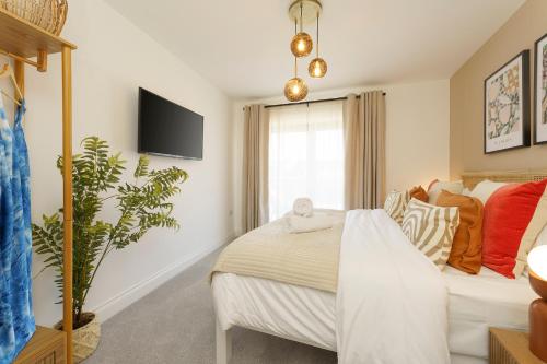 布里斯托Alba - 2 Bedroom Luxury Apartment by Mint Stays的卧室配有一张床,墙上配有电视。