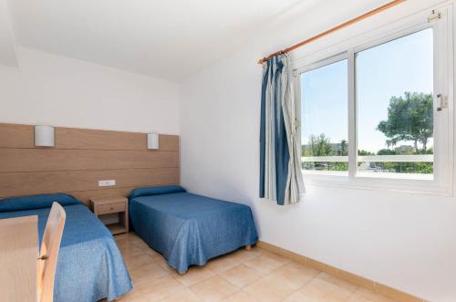 阿尔库迪亚港Mariner Club的客房设有两张床和窗户。