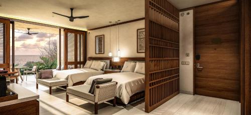 CihuatlánFour Seasons Resort Tamarindo, México的酒店客房设有两张床和一个阳台。