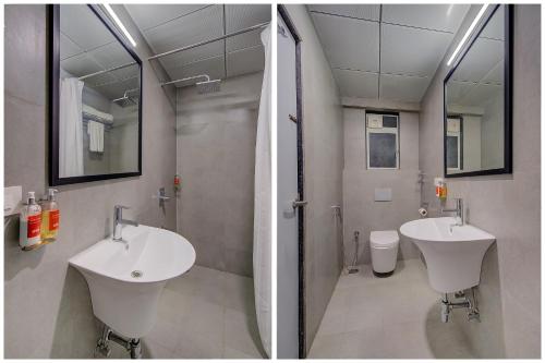 孟买Hotel Unicontinental的浴室设有2个水槽、卫生间和镜子。