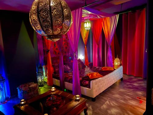 瓦朗西纳loveroom21的一间卧室配有一张带色彩缤纷窗帘和吊灯的床。