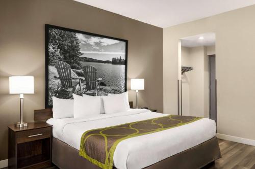 萨尼亚超级8萨尼亚酒店的酒店客房设有一张大床和两盏灯
