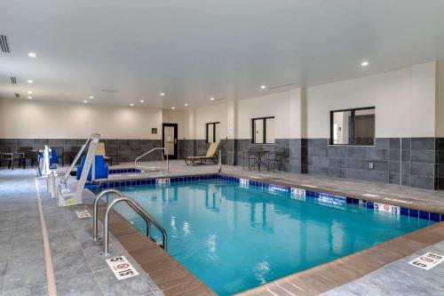 帕迪尤卡Comfort Suites的大楼内的一个蓝色海水游泳池
