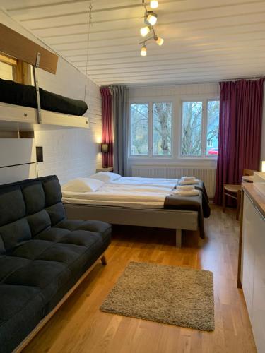 FjälkingeIvögården Mat & Vingård的一间卧室配有一张床和一张沙发