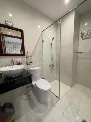 胡志明市SaiGon Europe Hotel的浴室配有卫生间、盥洗盆和淋浴。