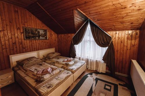 亚布卢尼齐亚Toga cottage的木间设有两张床,设有窗户