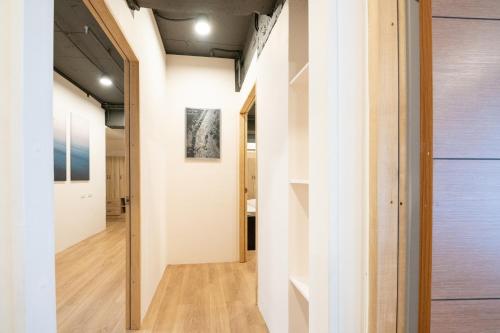 台北希尔商旅-西门馆的开放式走廊设有白色墙壁和木地板
