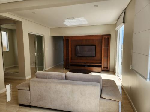 迪亚曼蒂纳Apto inteiro de luxo em Diamantina的带沙发和电视的客厅