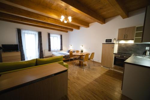特热邦Apartmany 21 Třeboň的厨房以及带桌子和沙发的客厅。