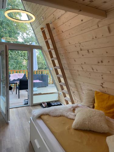 斯玛杰克托莱塞Glamping Holiday House with hot tub and sauna- Hisa oddiha的木墙客房的一张床位