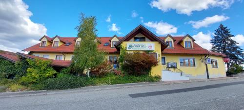 Maria BildLandrasthaus Maria Bild的街上有红色屋顶的黄色房子
