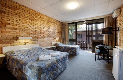 努萨维尔努萨别墅酒店的酒店客房设有一张床、一张书桌和一台电视机。
