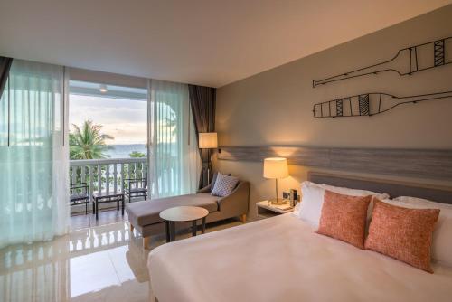 奥南海滩Centara Ao Nang Beach Resort & Spa Krabi - SHA Plus的酒店客房设有一张床和一个阳台。