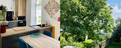 佩罗斯-吉雷克CLINT HOUSE - Appartement "l'Île aux Moines"的一张桌子的房间,两幅树的照片