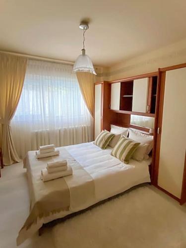 布加勒斯特Lovely & quiet 1-bedroom condo with free parking的窗户客房内的一张大白色床