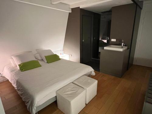 斯特拉斯堡城市一室公寓酒店的卧室配有带绿色枕头的大型白色床